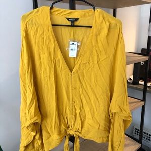 Long-sleeved, mustard yellow, front tie blouse.